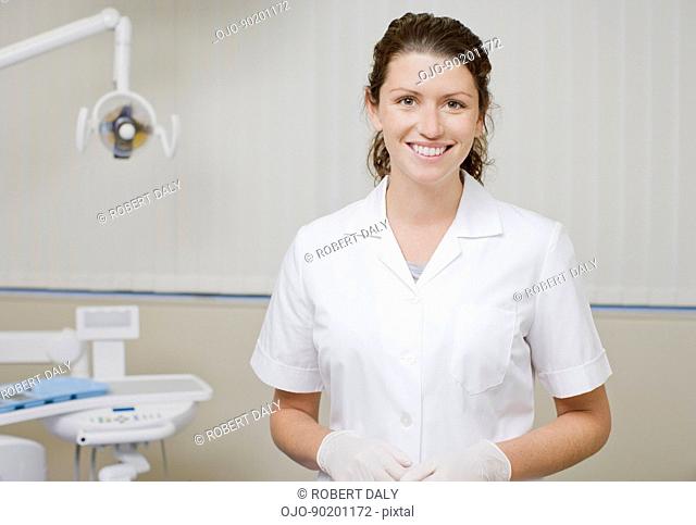 Dental hygienist standing in dentists examination room