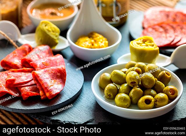 Assortment of tapas and antipasti on black background. Charcuterie boards of assorted appetizers
