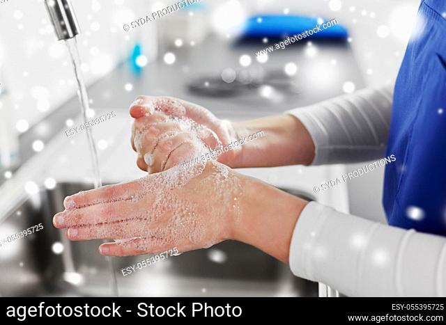 doctor or nurse washing hands with liquid soap