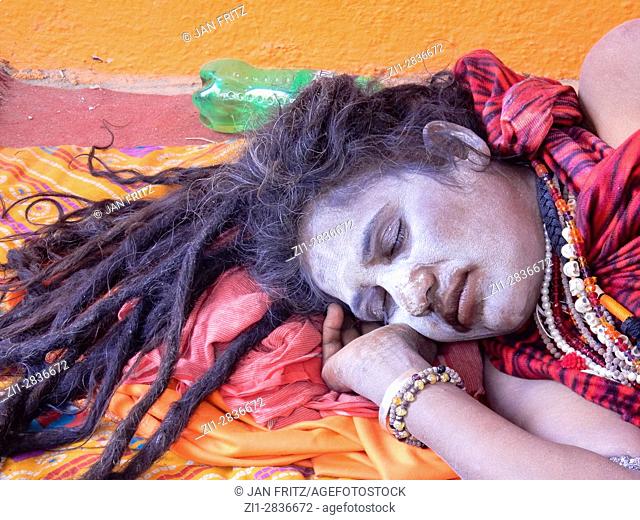 sleeping indian sadhu at festival, junagadh, gujarat, india