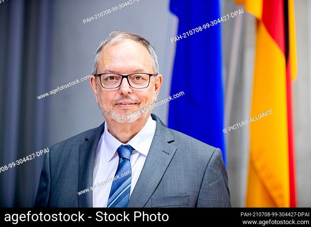 08 July 2021, Berlin: Georg Thiel, Federal Election Commissioner, stands in front of the flags before the start of the Federal Election Committee meeting in the...