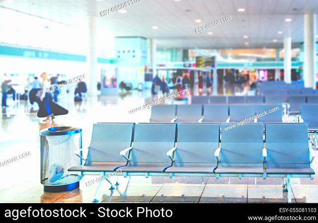 Row of empty chairs in the departure lounge of an international airport. Travel concept