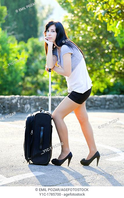 Young woman tired wih a suitcase