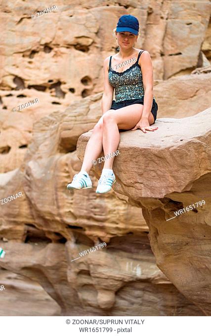 girl sitting on a rock
