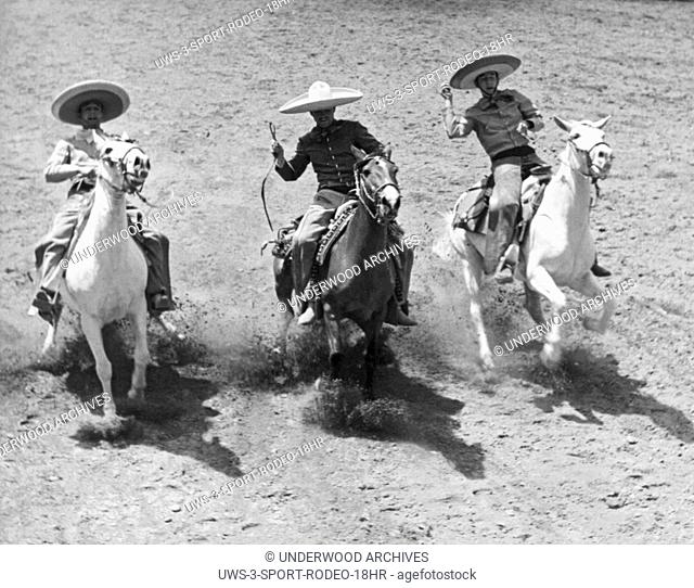 Mexico, 1951 Charros competeing in the short stop where their mounts come to a gallop and then they rein in their horses simultaneously