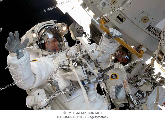 Astronaut Mike Foreman, STS-129 mission specialist, waves at a camera-bearing crewmate during the second space walk of Atlantis' visit to the International...