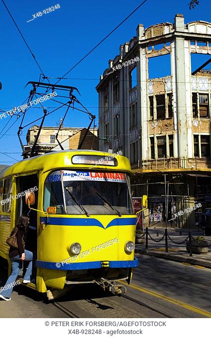 Woman getting onto a tram along Mula Mustafe Baseskije street in Sarajevo Bosnia Herzegovina Europe