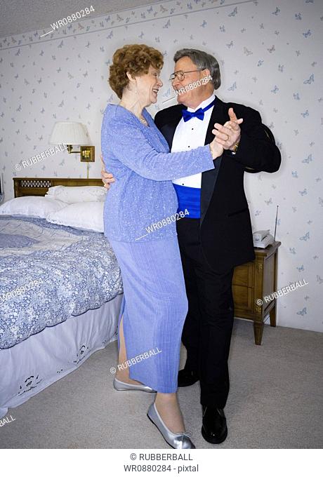 Senior couple dancing in the bedroom
