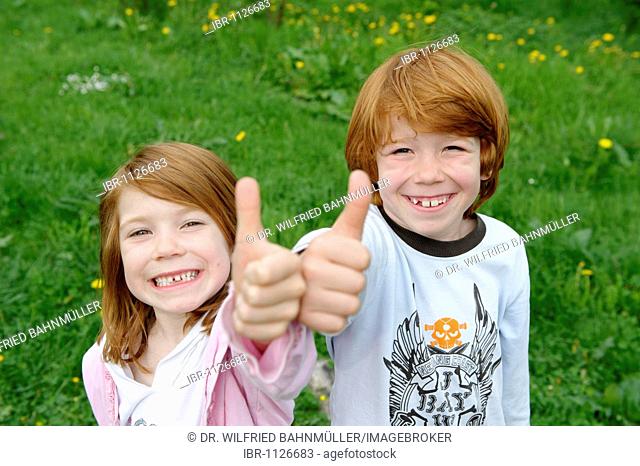 Girl and boy giving the thumbs up
