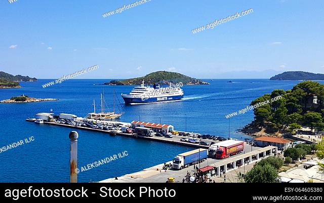 Skiathos, Greece - August 2023: Ferryboat approaching harbour at city of Skiathos at Skiathos island in Greece
