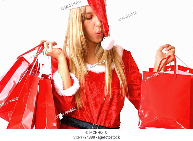 A young blonde woman in Santa Claus dress holding shopping bags - 01/01/2009