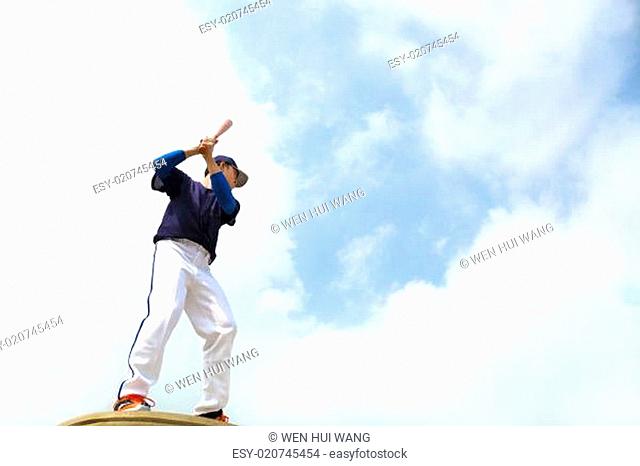 baseball player make a pose for hitting ball with blue sky