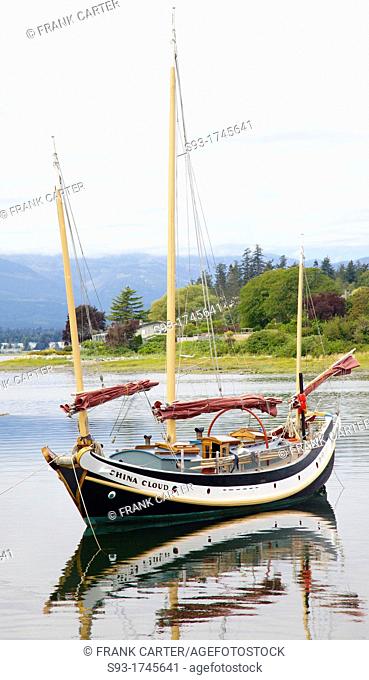 A view of the Comox harbour, with a sail boat in the foreground