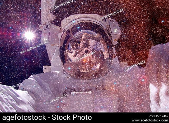 Astronaut. Nebula, cluster of stars in deep space. Science fiction art. Elements of this image furnished by NASA