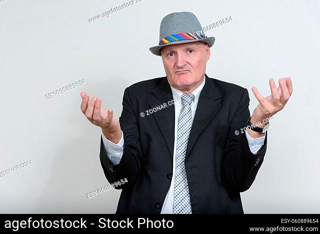Studio shot of senior businessman with gray hair wearing suit against white background