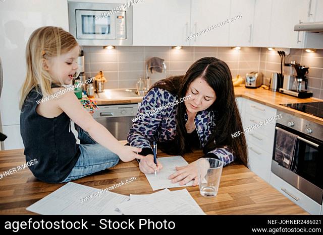 Women with daughter in kitchen