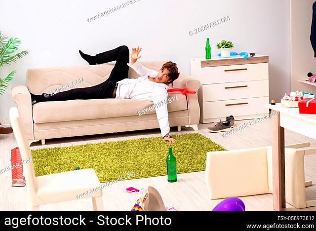 Young man having hangover after party