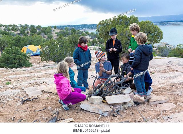 Children building campfire on field trip