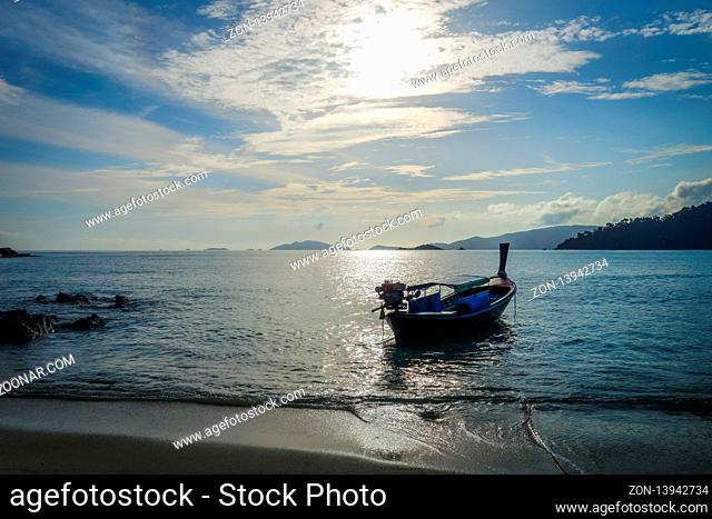 Tropical beach and boat at sunset in Koh Lipe, Thailand