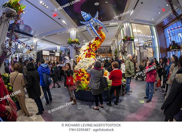 Hordes of visitors descend on Macy's flagship department store in Herald Square in New York which is festooned with floral arrangements for the 45th annual...