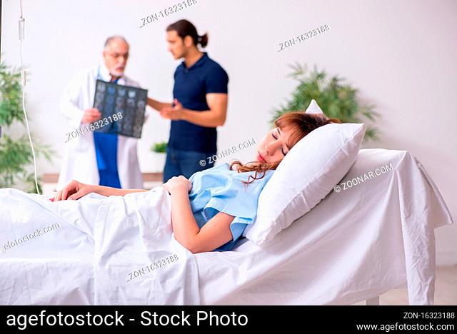 Husband visiting sick wife in the clinic