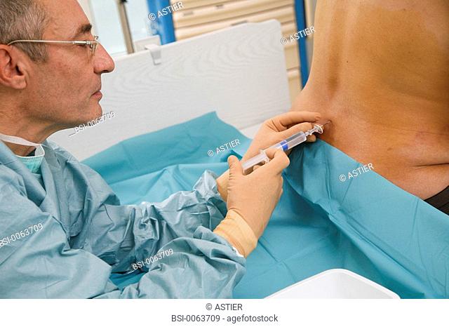 Photo essay at the maternity of Saint-Vincent de Paul hospital, Lille, France. Labor delivery recovery room, labor ward. The anesthesiologist is placing the...