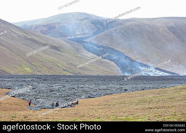 Grindavik, Iceland - July 26, 2021: A unique natural attraction. People are walking over the new lavafield of the volcano eruption at Fagradalsfjall