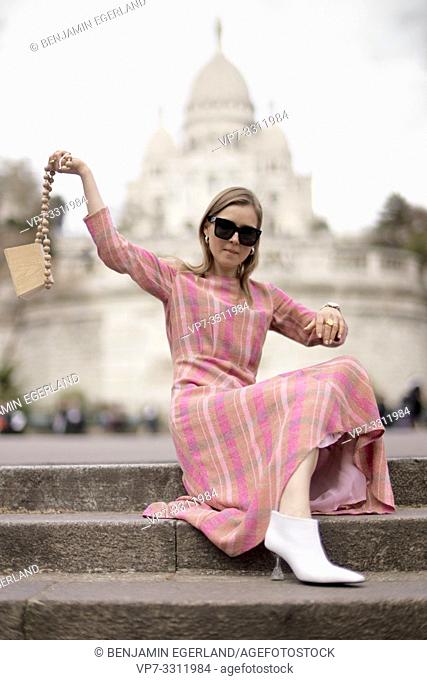 stylish blogger woman in front of touristic sight Basilica Sacré-Cœur, during fashion week, in city Paris, France, in city Paris, France