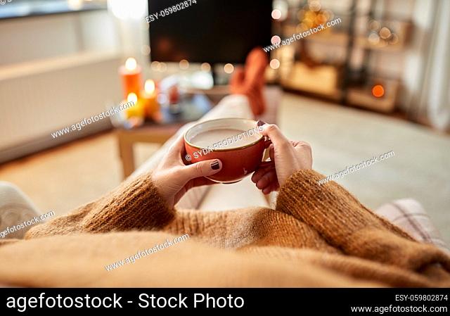 hands of woman drinking hot chocolate at home
