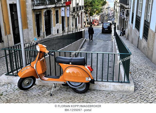 Orange Vespa leaning on a railing, Chiado district of Lisbon, Portugal, Europe