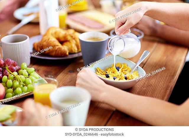 hands of woman eating cereals for breakfast