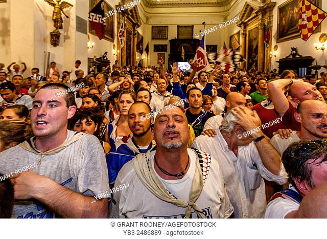Members Of The Istrice (Porcupine) Contrada Give Thanks For Their Palio Victory In The Provenzano Church, The Palio di Siena, Tuscany, Italy