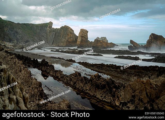 A rocky and wild coast with stormy waves hitting the shore