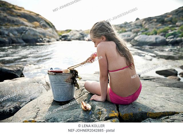 Girl making hot dogs at sea