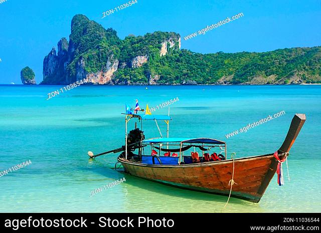 Longtail boat anchored at Ao Loh Dalum beach on Phi Phi Don Island, Krabi Province, Thailand. Koh Phi Phi Don is part of a marine national park