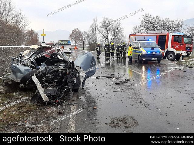 03 December 2020, Bavaria, Grassau: A destroyed car is standing at the scene of an accident. Several children have been injured in a school bus accident in...