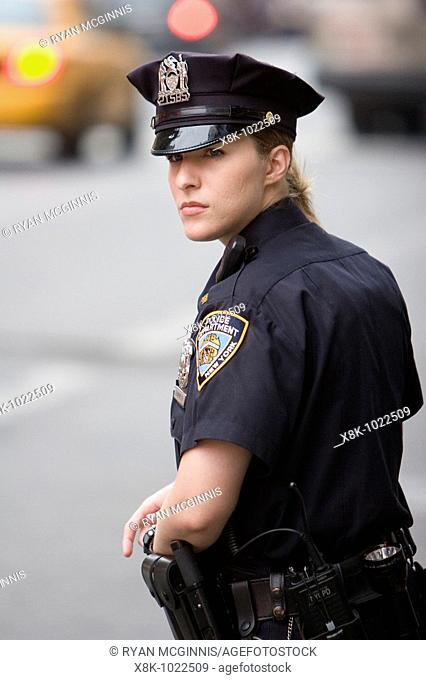 A female police officer watches traffic in New York City New York USA June 4 2008