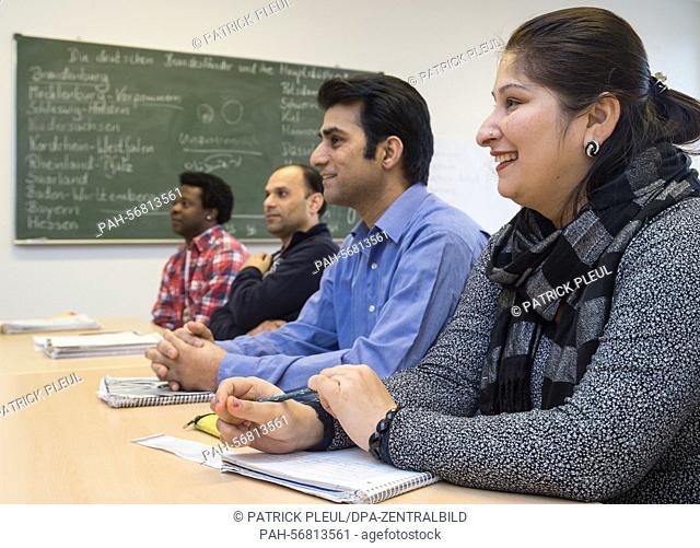 Asylum seekers Shally and her husband Rakesh Sharma from Afghanistan take part in a German class in Strausberg, Germany, on 12 March 2015