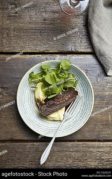 Fried ox tongue with mash potatoes and rocket