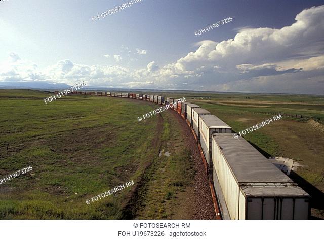 train, railroad, A freight train stretches for miles along the tracks on the flat prairie near Blowning in the state of Montana