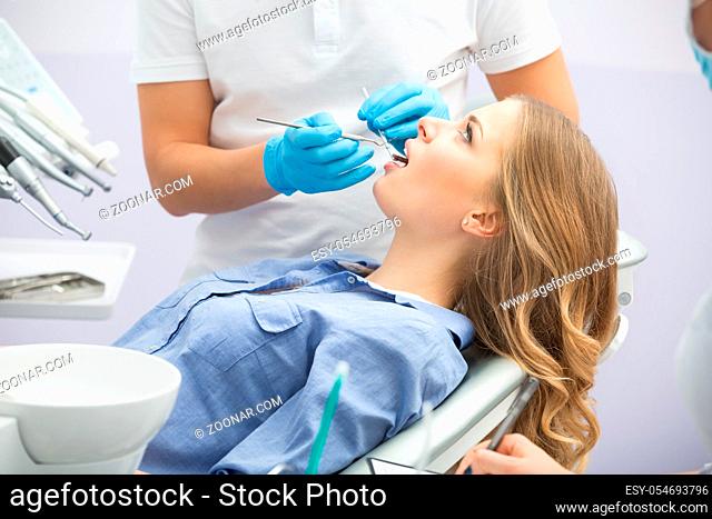 Girl with beautiful white teeth on reception at the doctor dentist