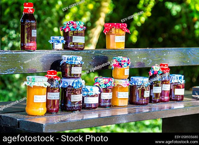 Market stall with home made jam in front of a house