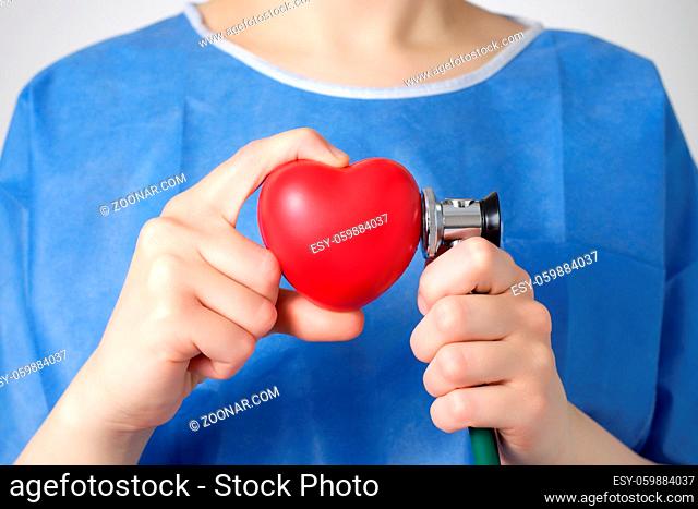 Red heart and stethoscope in the hand of a doctor