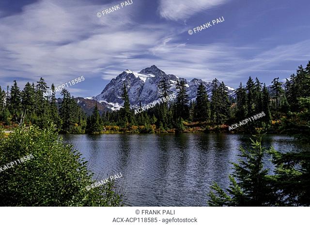 WASHINGTON - Mount Shuksan reflecting in Picture Lake in Heather Meadows Recreation Area in the North Cascades.Fall colours are abundant in the vegetation