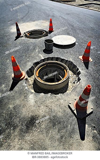 Installation of two manhole covers, Obersendling, Munich, Upper Bavaria, Bavaria, Germany