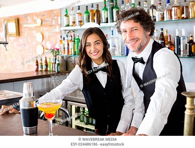 Portrait of waiter and waitress smiling