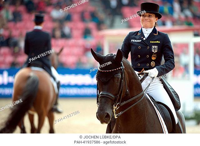 Equestrian Kristina Sprehe smiles after her performance on her horse Damon Hill during the team dressage event at the European Show Jumping and Dressage...