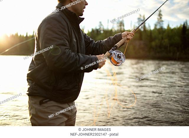 Man fly-fishing in river