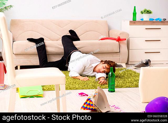 Young man having hangover after party