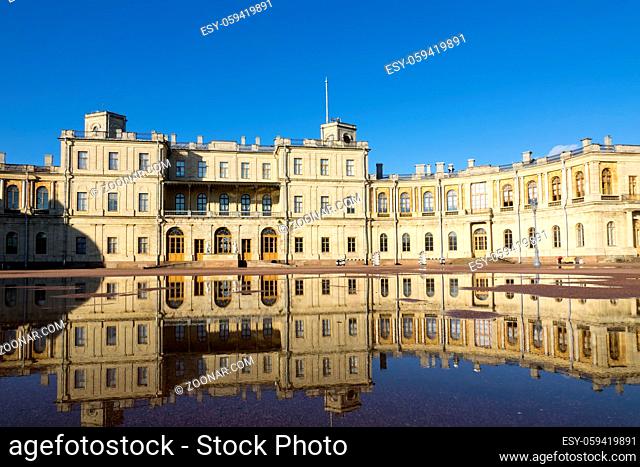 Russia, suburb of St. Petersburg. Great Gatchina Palace (1766 — 1781) and parade-ground. Reflection in pools after a rain